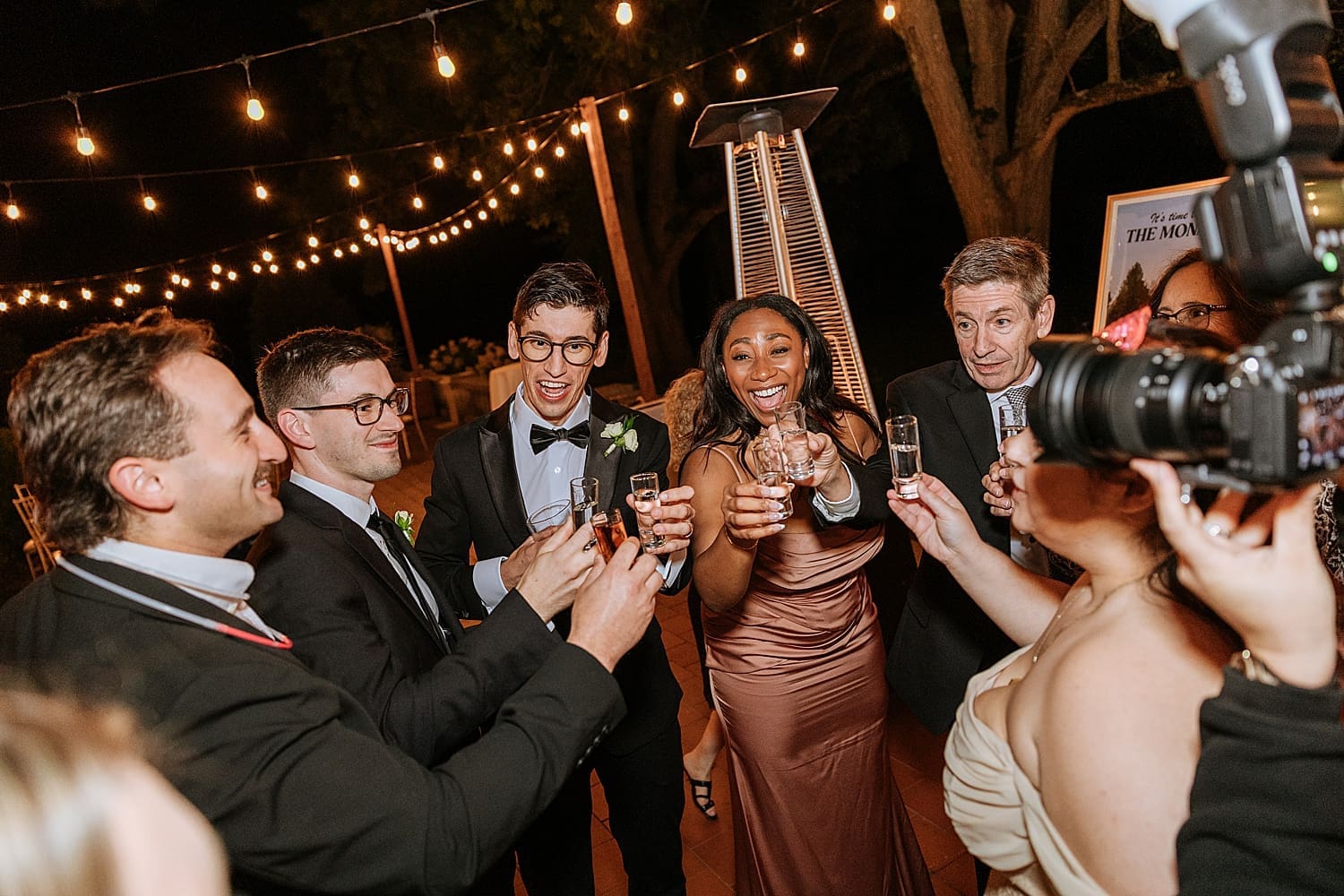 guests hold up shots during reception for a toast by Kelly Jean Photography