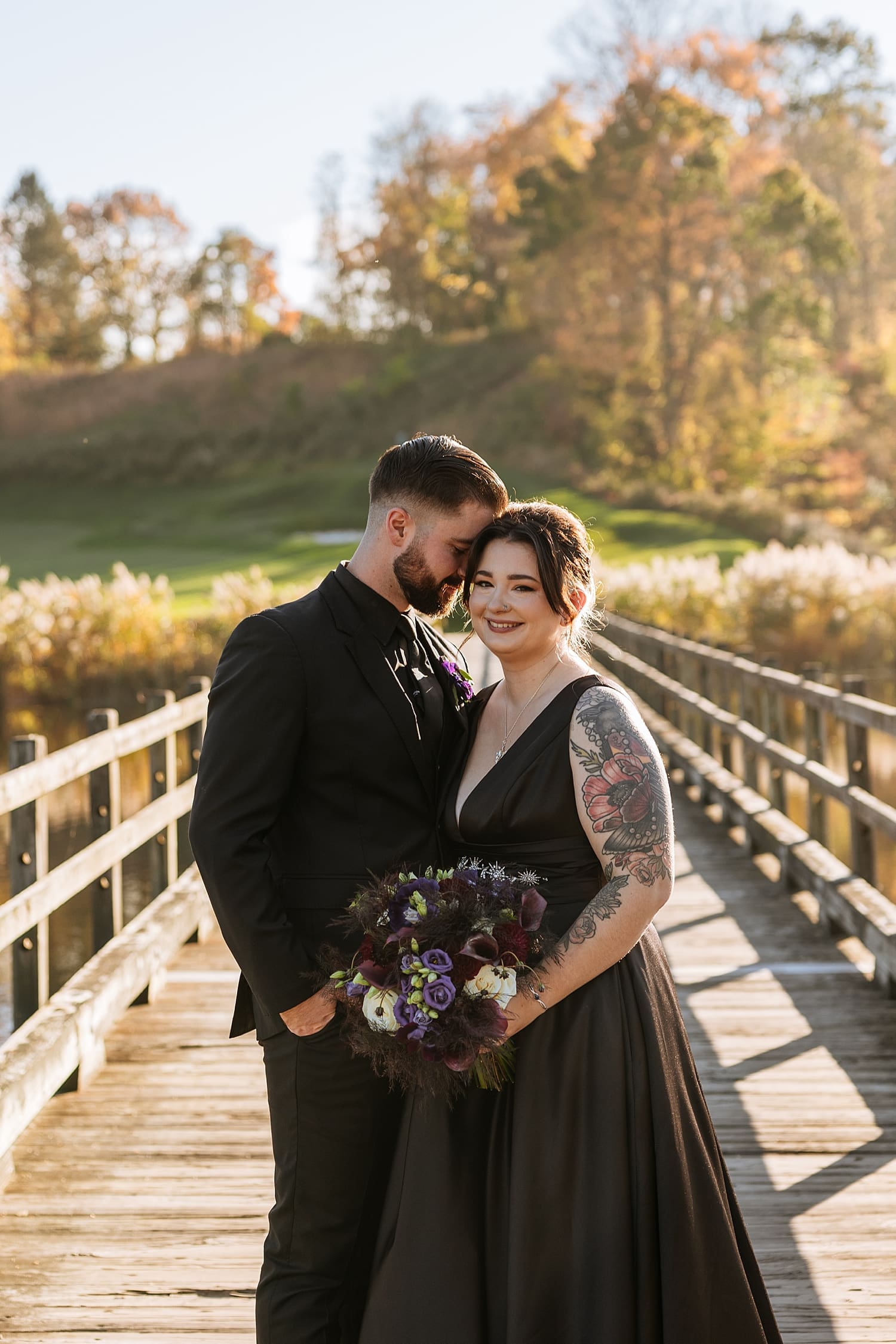couple in black formal attire at dock at Fall Venues in the Hudson Valley