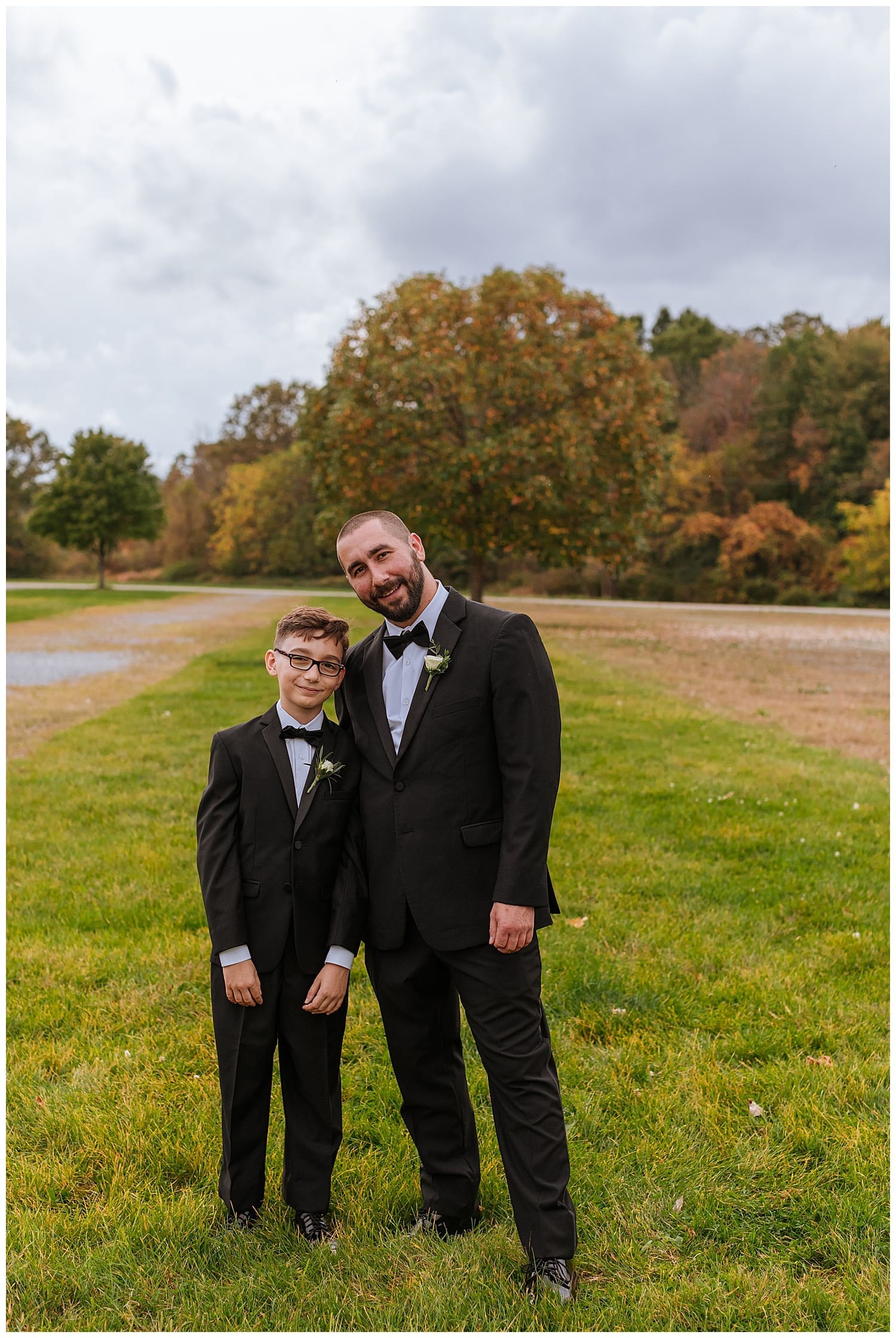groom stands with new son by Hudson Valley photographer