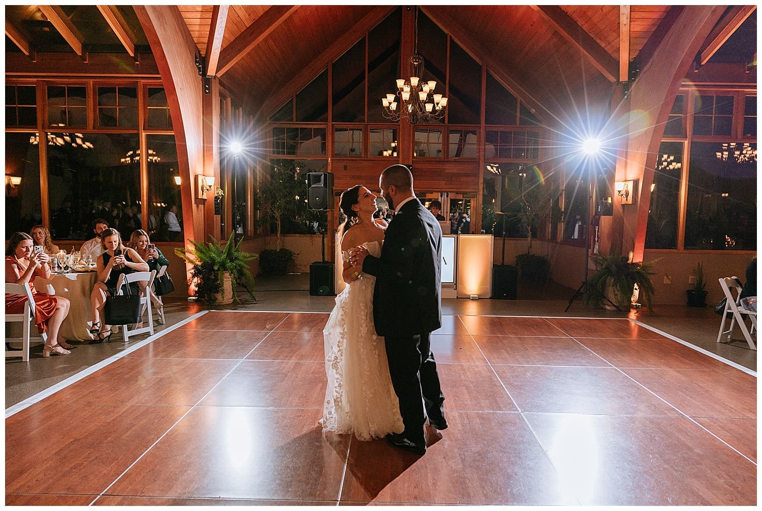 newlyweds share a dance on dimly lit reception floor by Kelly Jean Photography